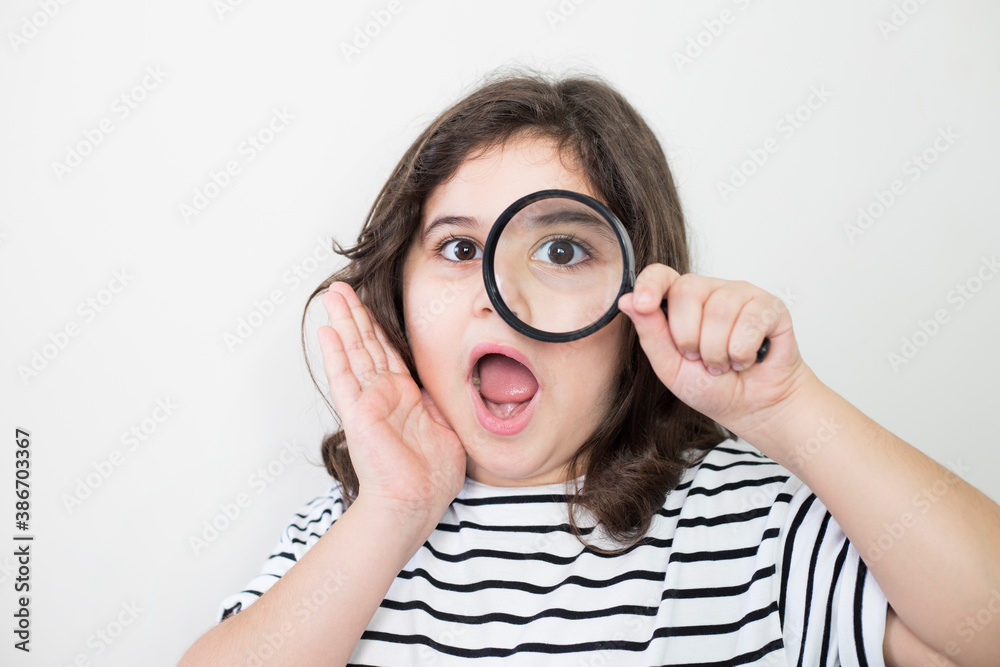 little girl looking with a magnifying glass little girl looking with a magnifying glass