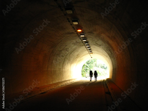 Silhouette of hikers in a tunnel