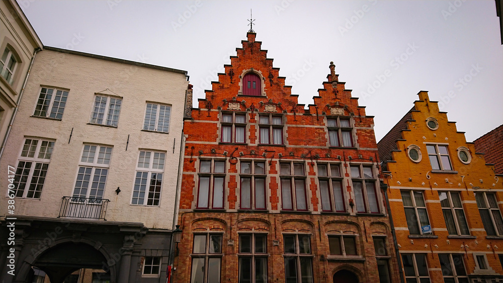 Bruges, Belgium - May 12, 2018:  Roofs And Windows Of Old Authentic Brick Houses On Street Sint-Jakobsstraat