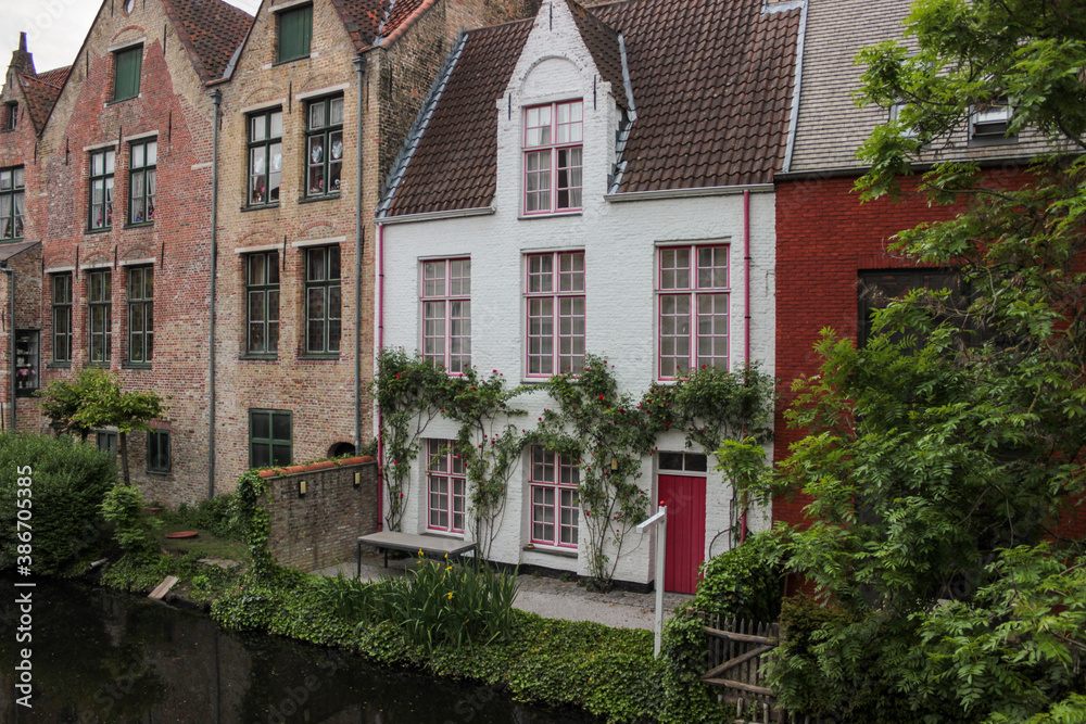 Bruges, Belgium - May 12, 2018: Unique Houses Above A Water Channel