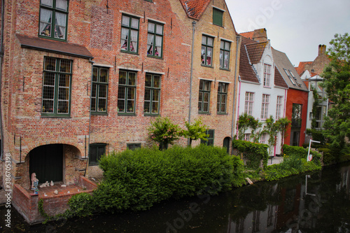 Bruges, Belgium - May 12, 2018: Unique Houses Above A Water Channel