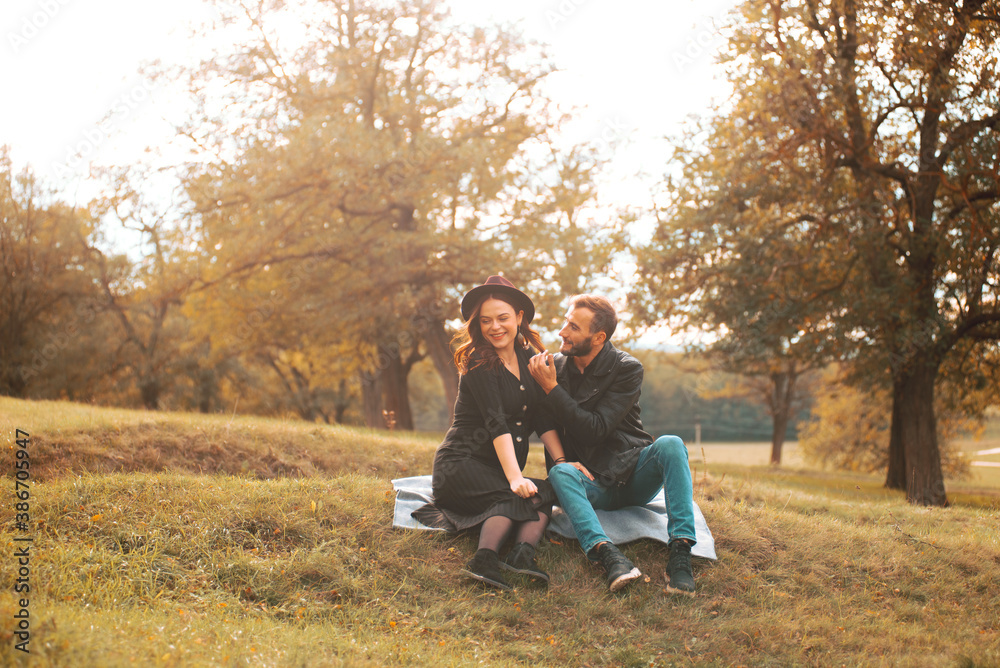 Cheerful young family having a great time in park a pregnant woman and her husband