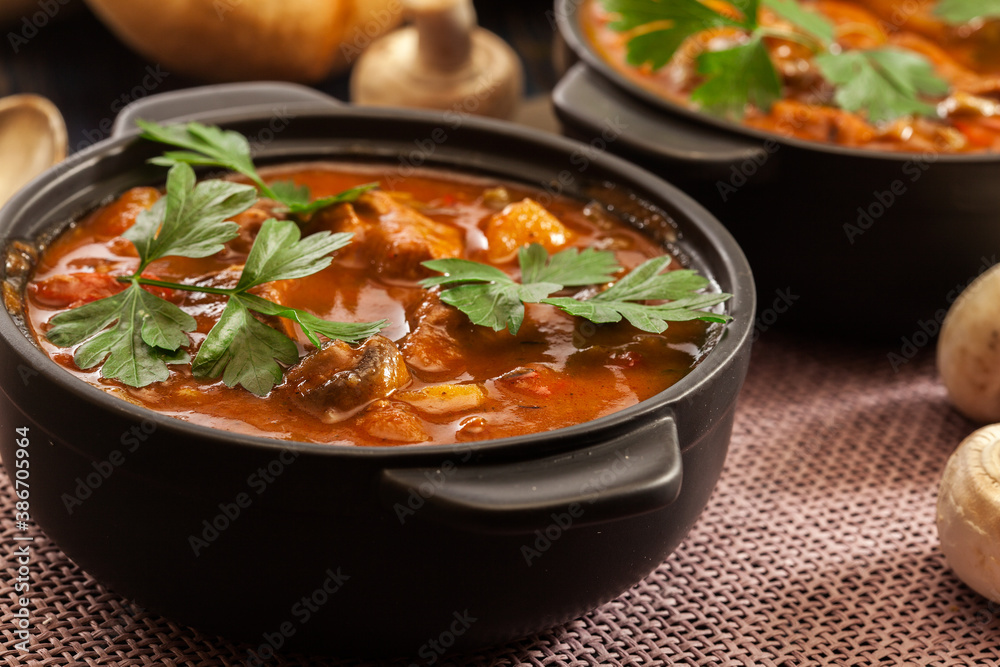 Stew soup with meat, potatoes, mushrooms and red pepper