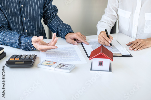 Real estate broker agent being analysis and making the decision a home estate loan to customer, Agent man is using calculator to presentation detail and waiting for his reply to finish