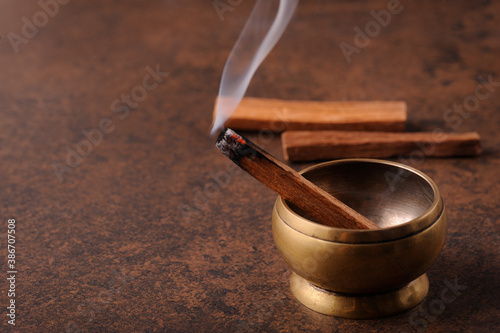 Smoking herbal incense.The smoke of palo santo stick.