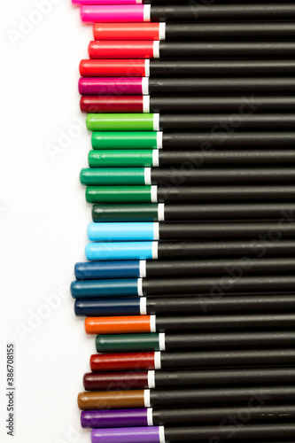 Black pencils with colored tips, white background
