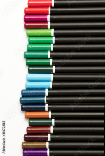 Black pencils with colored tips, white background