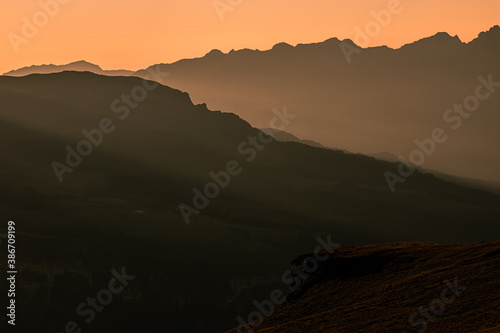 sunrise over the swiss Alps, Switzerland. sillhouettes of mountains © Tereza