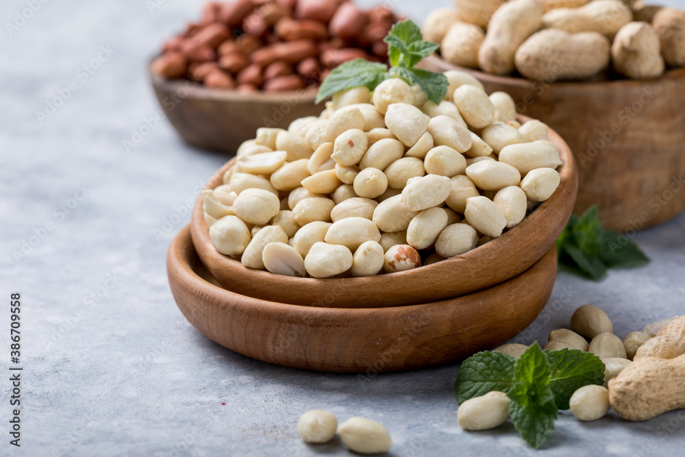 Raw dried fresh peanut nuts on a stone background Raw dried fresh peanut nuts on a stone background