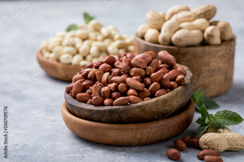 Raw dried fresh peanut nuts on a stone background
