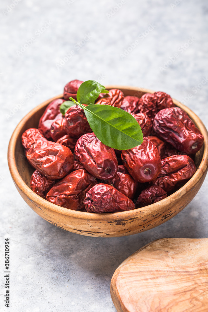 Jujube fruits ( red date, Chinese date, Ziziphus jujuba ) in dish on rustic background Jujube fruits ( red date, Chinese date, Ziziphus jujuba ) in dish on rustic background