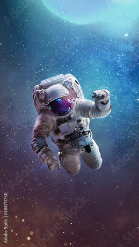 Astronaut in bright galaxy. Universe and spaceman. Astronaut in the outer space. Vertical wallpaper. Elements of this image furnished by NASA 