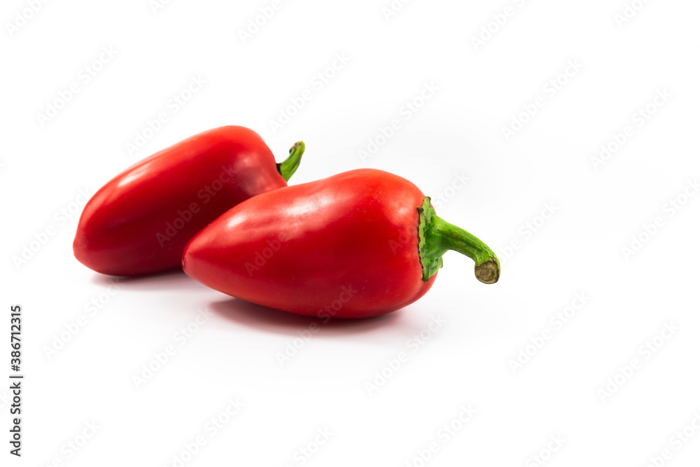 Two perfect red chili peppers on white isolated background, product for dishes