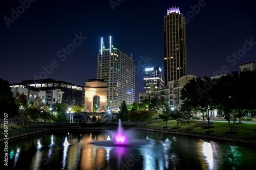 City landscape with skyline and lake at night