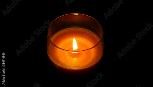 Candle fire in a glass on a black background.