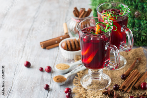 Mulled wine with christmas decorations. Christmas hot drink on wooden table with copy space.