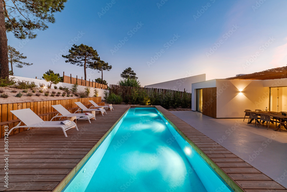 Modern house with garden swimming pool and wooden deck - obrazy, fototapety, plakaty 