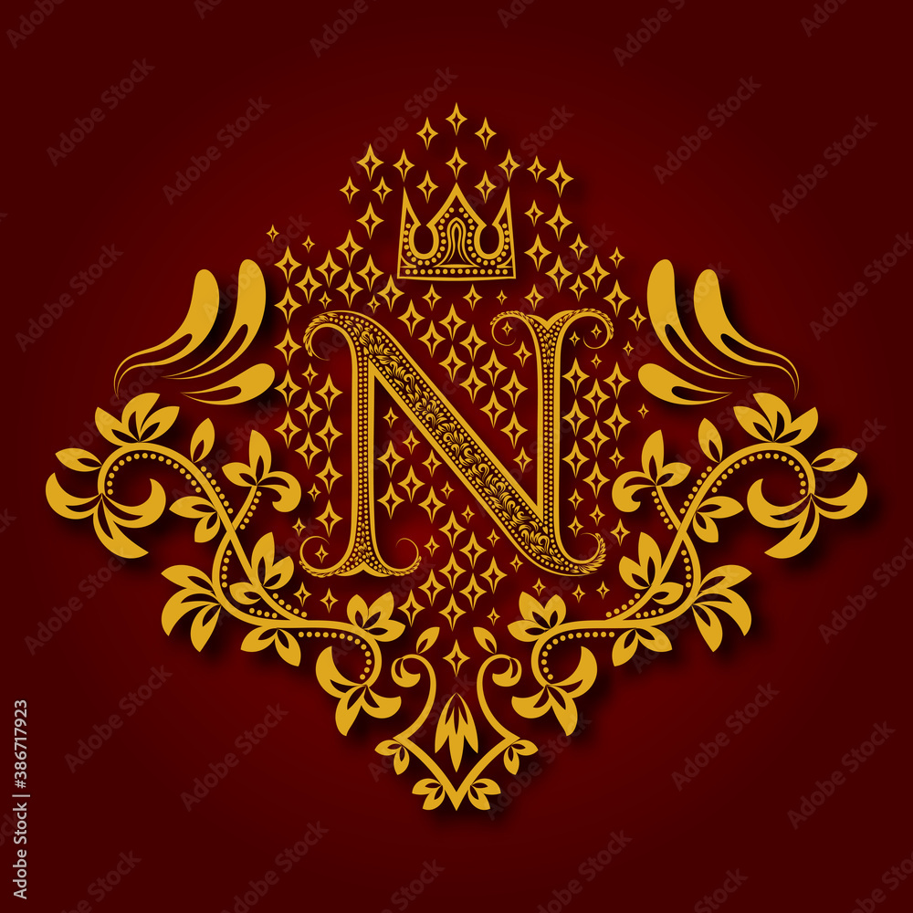 Letter N heraldic monogram in coats of arms form. Vintage golden logo with shadow on maroon background. Letter N is surrounded by floral elements of design.