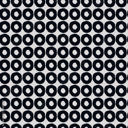 Seamless geometric pattern with hand drawn uneven black rings on gray background for surface design and other design projects