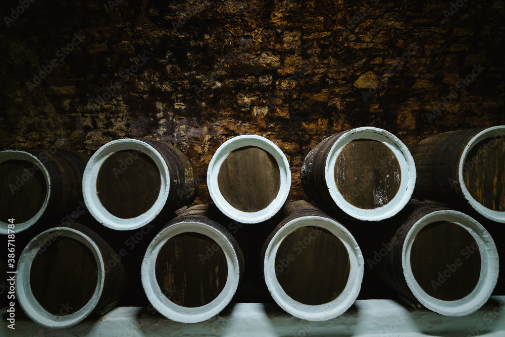 Old wine oak barrels in the cellar at the winery