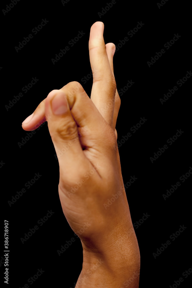 Side view of a male hand demonstrating Vayu mudra isolated on black background. Side view of a male hand demonstrating Vayu mudra isolated on black background.