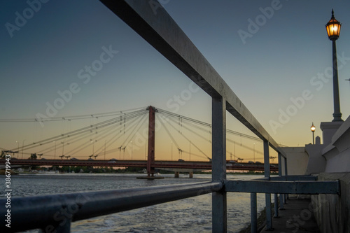Silhouette Puente Colgante Marcial Candioti Over Santa Fe River Against Sky. photo