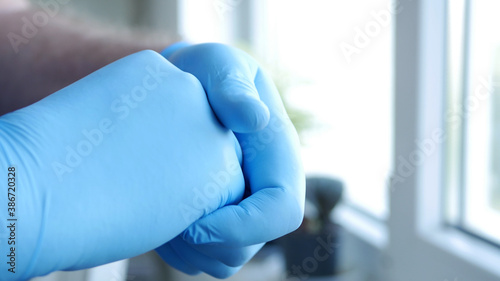 Image with Doctor Hands Wearing Surgical Gloves Needed in Protection Against Coronavirus Contamination