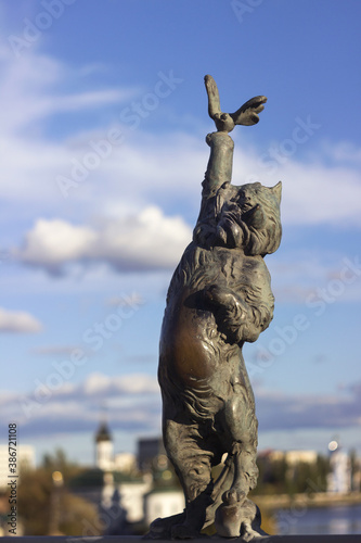 Vinnytsia, Ukraine -  14 October, 2020. Bronze sculpture of a cat with a butterfly on the Kiev bridge in Vinnitsa. Sculpture of an animal on the bridge over the Pivdennyi Buh River photo