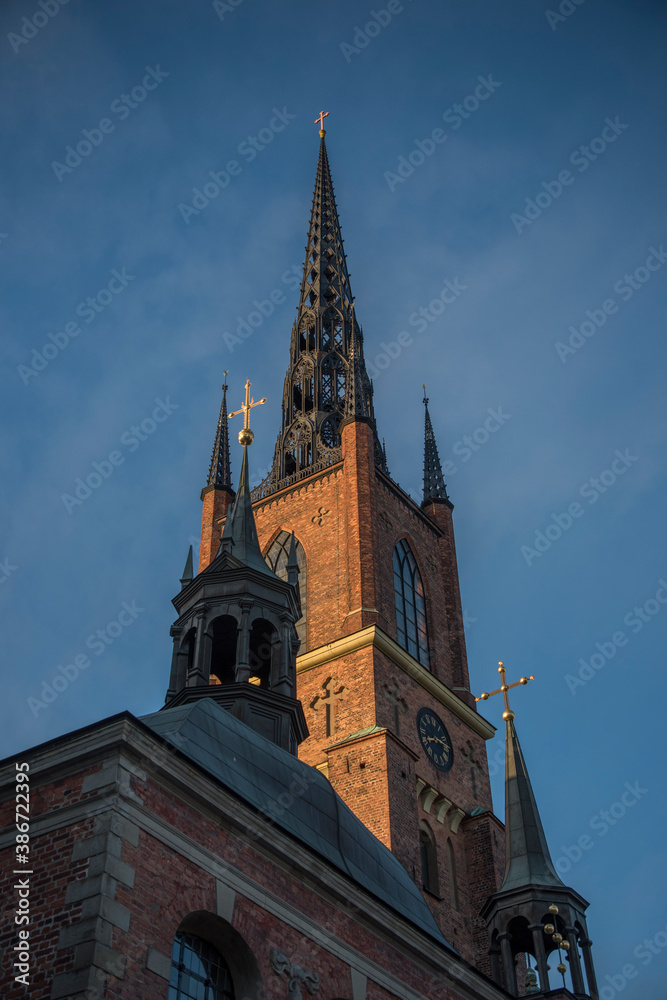 Brick and steel tower on the church Riddarholmskyrkan on the island Riddarholmen  in the old town Gamla Stan in Stockholm an early morning
