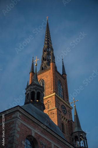 Brick and steel tower on the church Riddarholmskyrkan on the island Riddarholmen in the old town Gamla Stan in Stockholm an early morning