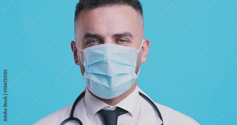 Medical approval. Friendly doctor in protective mask nodding head, agreement concept Medical approval. Friendly doctor in protective mask nodding head, agreement concept