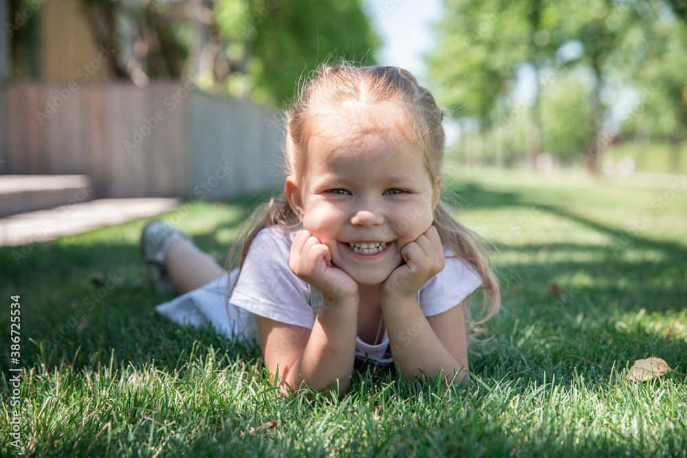 a little girl smiles, shows her teeth. large portrait. a little girl smiles, shows her teeth. large portrait.
