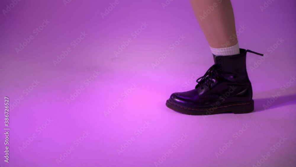 custom made wallpaper toronto digitalBlack boots of a funky dancer close up shot on violet background indoors in studio. Dance classes, legs jumping repeating movement, hip hop, jazz style