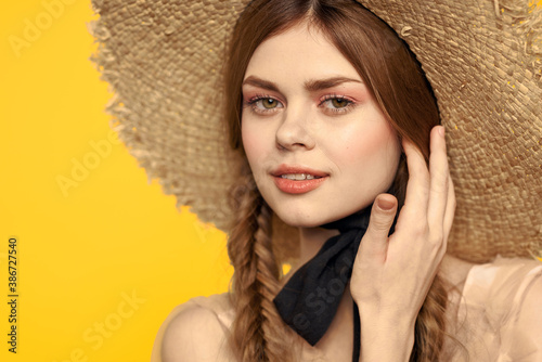 Romantic woman in hat having fun on a yellow background and sunglasses black ribbon model portrait