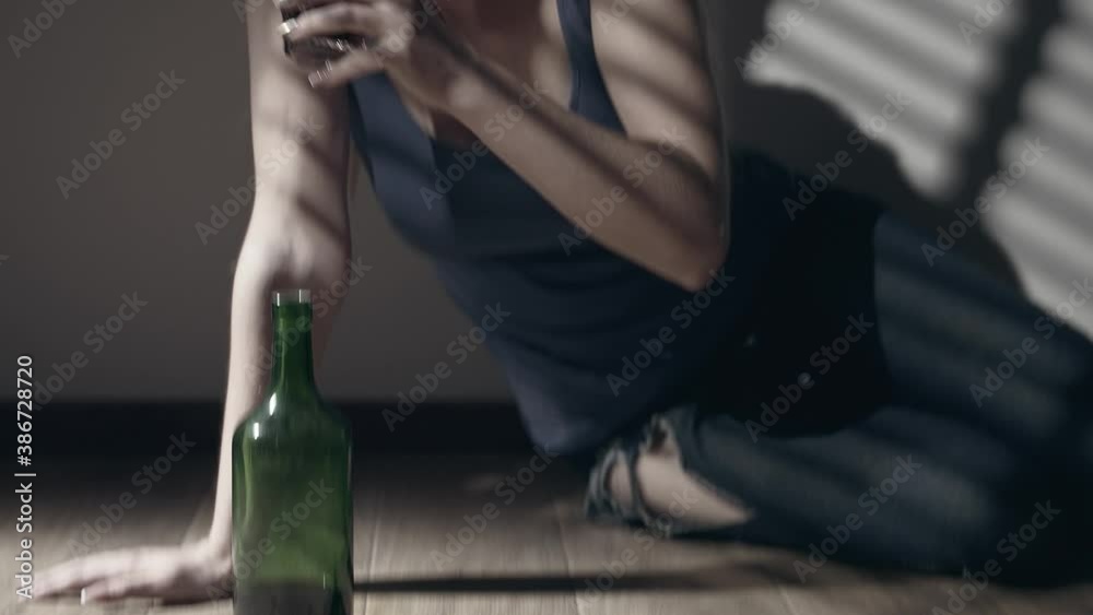 Miserable woman in depression, drinking alcohol