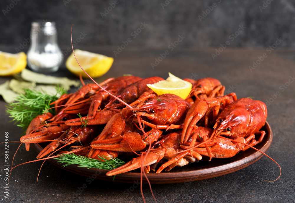 Red crayfish with dill, bay leaf and lemon in a plate. Red crayfish with dill, bay leaf and lemon in a plate.