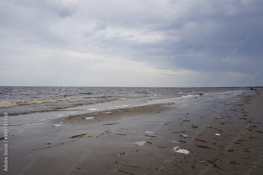 White sea beach on cloudy spring day