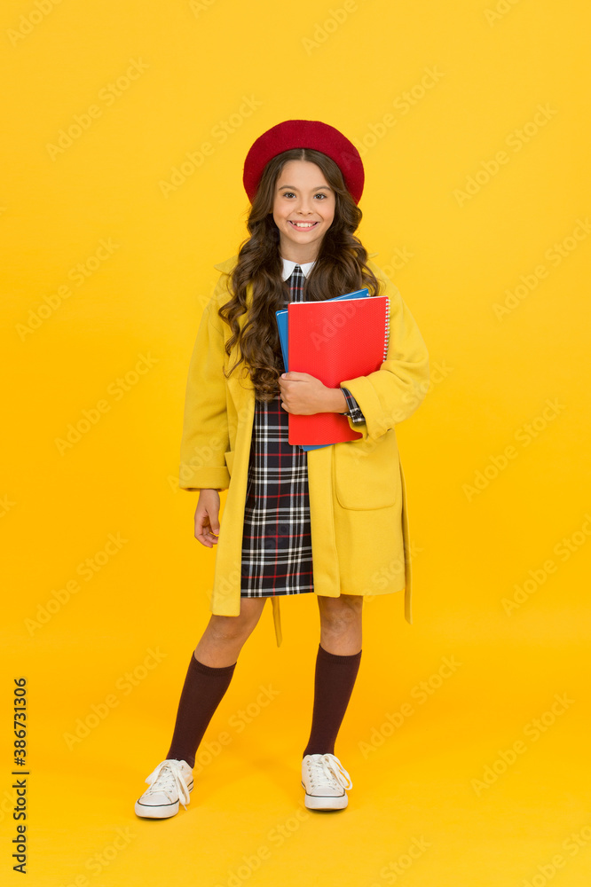 cheerful small girl in school uniform with notebooks, learning cheerful small girl in school uniform with notebooks, learning