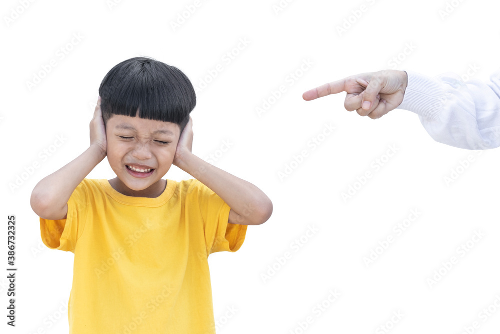 Asian little child covered his ear isolated on white background. Mother was pointing finger at her son. Domestic Family violence concept. sad and unhappy child. Asian little child covered his ear isolated on white background. Mother was pointing finger at her son. Domestic Family violence concept. sad and unhappy child.