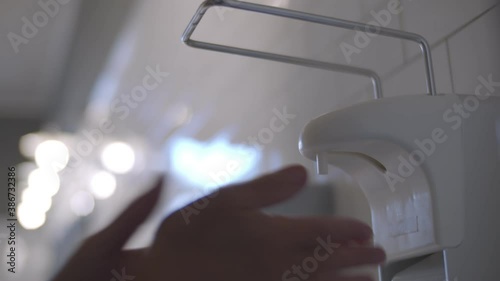 Wallpaper Mural Close up human washing hands with alcohol sanitizer dispenser in public toilet Torontodigital.ca