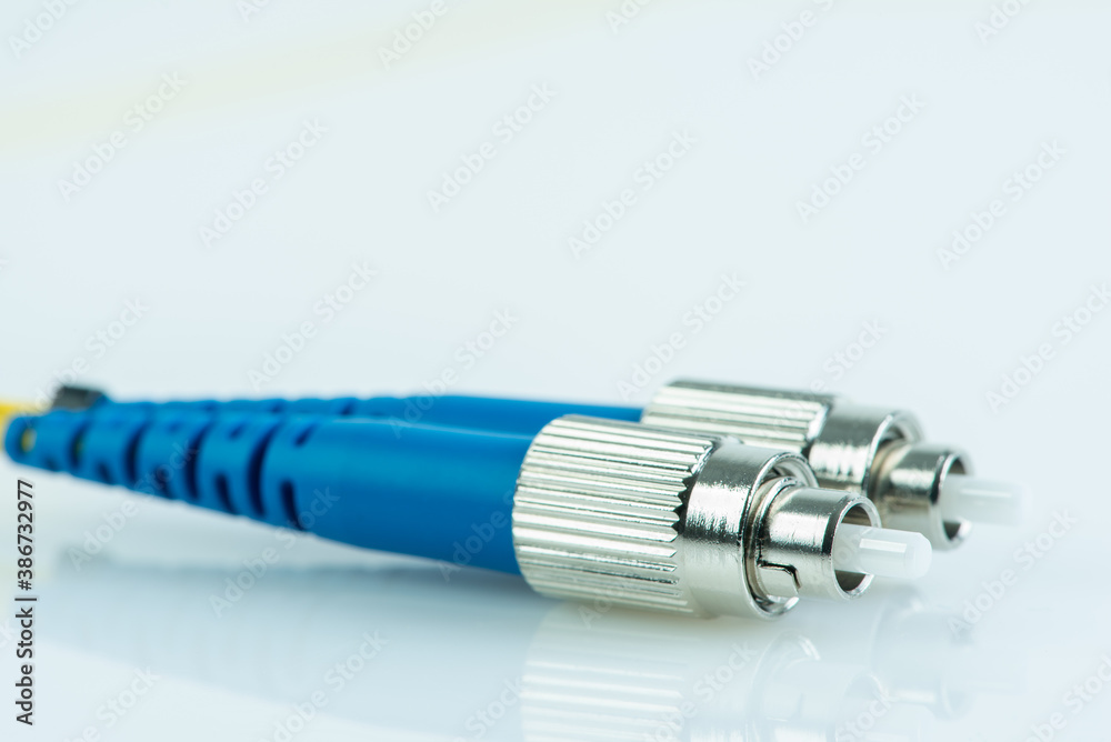 Close-up fiber optic single mode patch cord connector type FC with blurred background Close-up fiber optic single mode patch cord connector type FC with blurred background