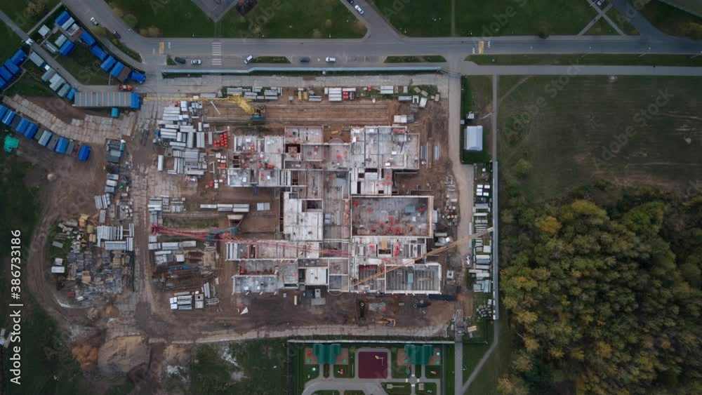 time-lapse of under construction site, crane, and car traffic transportation in city downtown. 4K Drone aerial top view time-lapse of under construction site, crane, and car traffic transportation in city downtown. 4K Drone aerial top view
