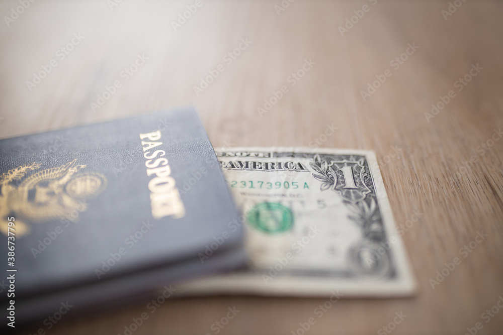 One-Dollar Bill Under a United States of America Passport One-Dollar Bill Under a United States of America Passport