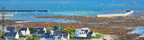 Panoramic aerial view of cottages and ocean coast at Ponte de Trenez, Brittany, France. Travel destinations, vacations, eco tourism, village, architecture, environmental damage and conservation photo