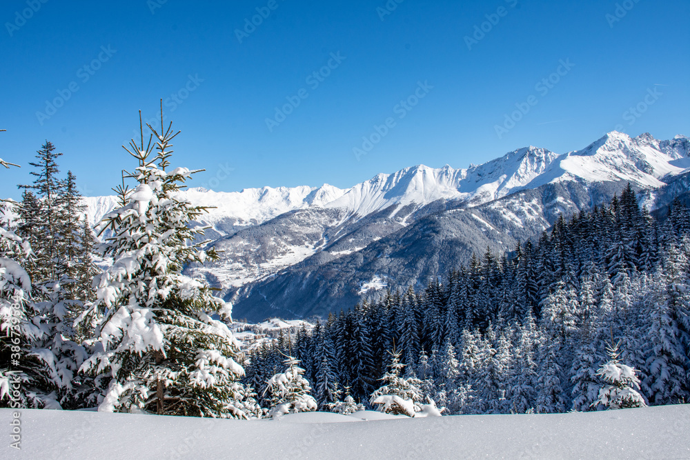 
View in winter of snowy mountain range in Serfaus-Fiss-Ladis, Tyrol, Austria with blue sky