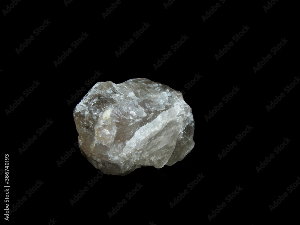 beige sample of the mineral fluorite on a black background