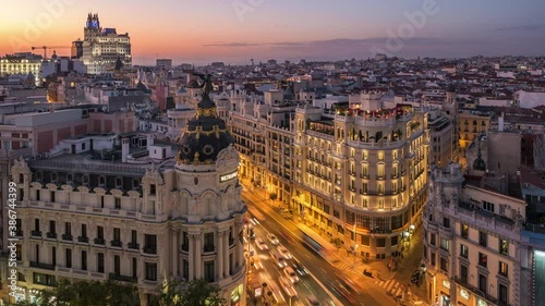 Time lapse view of sunset over historical buildings and traffic on Gran Via street in Madrid, the capital and largest city in Spain. photo