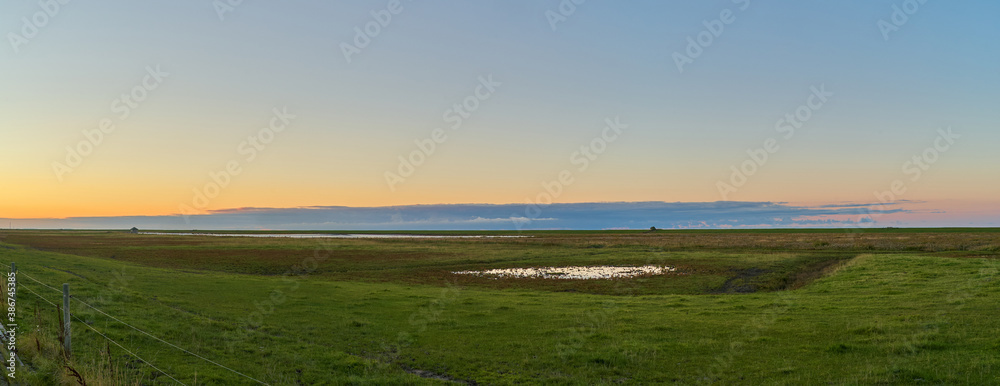 scenic evening panorama of the salt marshes at Langwarder Groden (Germany) after a beautiful sunset in autumn scenic evening panorama of the salt marshes at Langwarder Groden (Germany) after a beautiful sunset in autumn