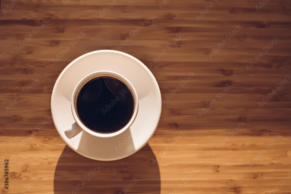 Cup of black coffee on bamboo desk Cup of black coffee on bamboo desk