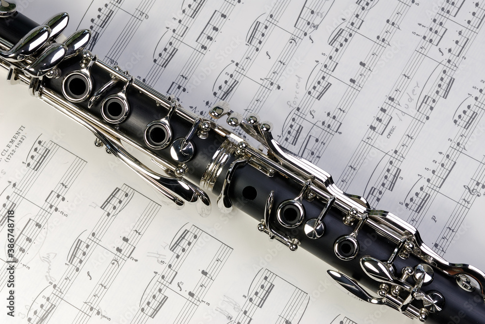 Obraz premium Boehm clarinet keywork on a sheet of music